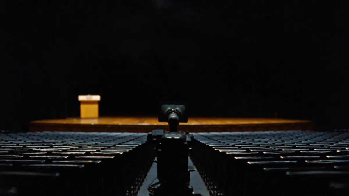 Cinema camera in the aisle of a university auditorium before a commencement ceremony